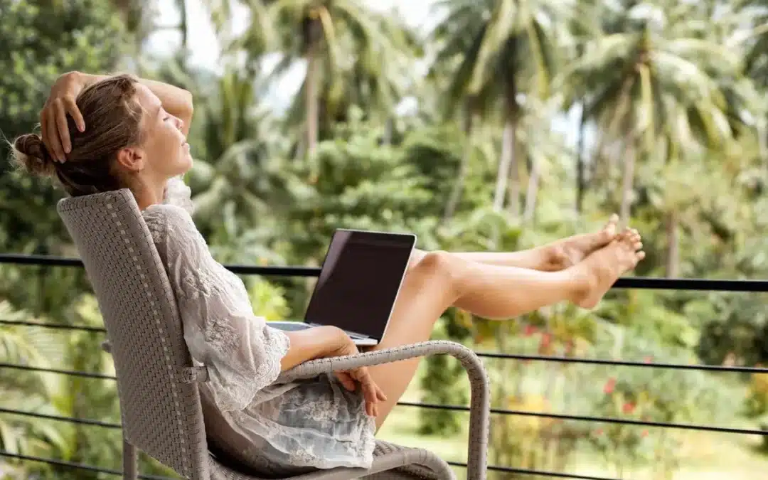 person working on a laptop in a tropical location top 5 cities for digital nomads to thrive